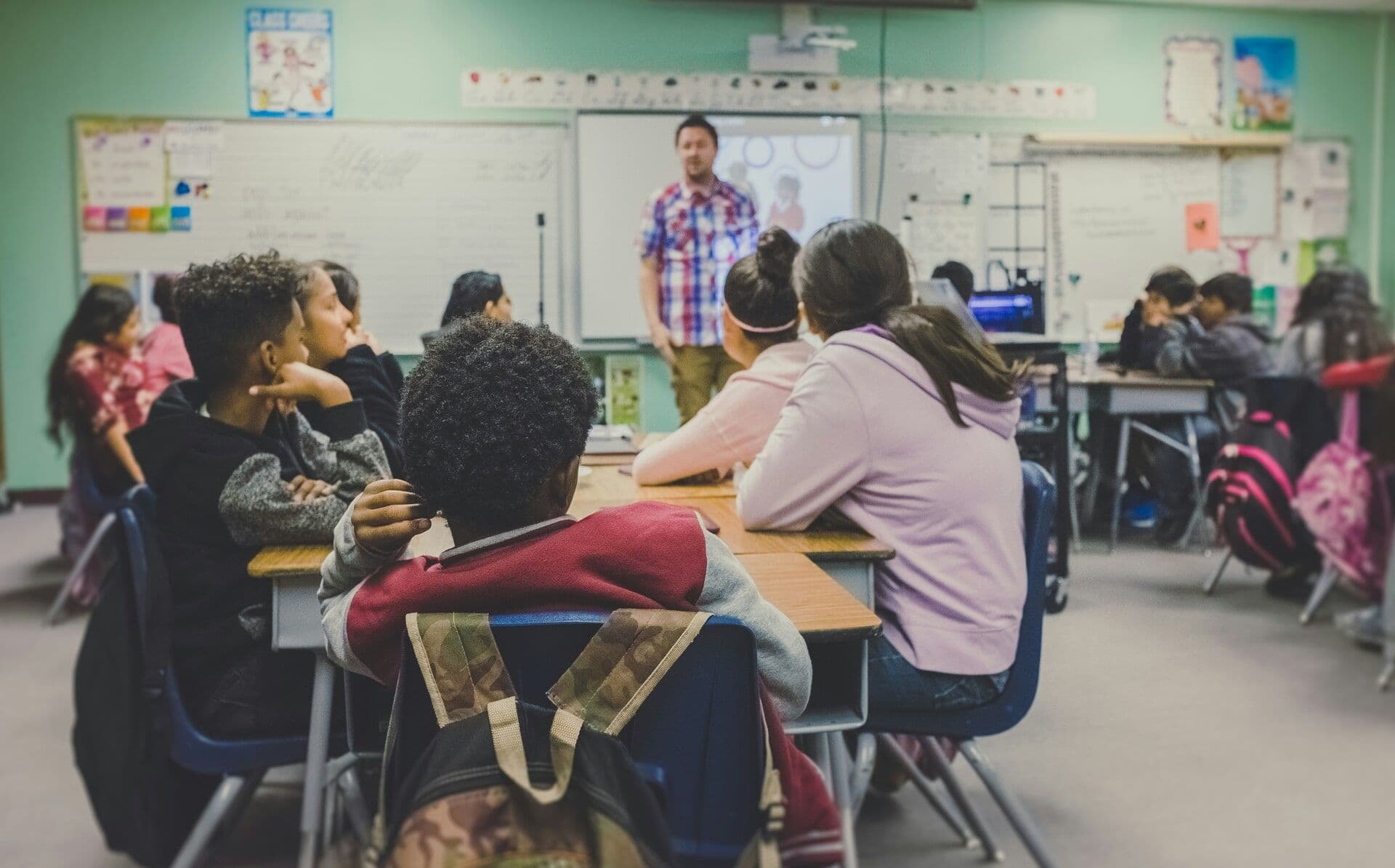 children participating in a classroom environment